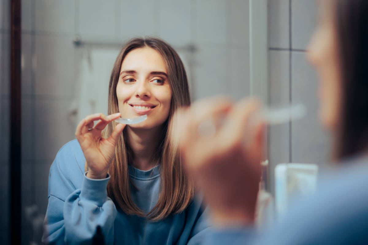 Woman holding her Invisalign.
